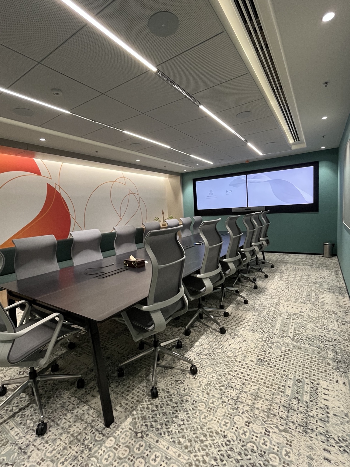 Omnyx deployed boardroom with dual displays and integrated conferencing